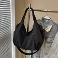 Grande borsa a tracolla in nylon nero con tracolla larga e tasche multiple funzionali - Nero