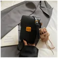 Mini black PU leather crossbody phone bag with gold clasp and brown puppy charm - Black With Pendant