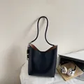 Chic black oily leather bucket bag with wooden bead charm and long shoulder strap - With Pendant / Black