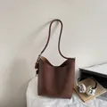 Minimalist dark brown leather bucket bag with top handle and wooden bead accessory - With Pendant / Brown