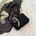 Black woven small crossbody bag with stylish chocolate charms and leather handle - Black