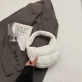 White quilted puffer crescent handbag with padded grid design and zipper closure - White