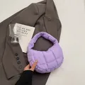 Chic light purple quilted hobo bag in soft nylon shown against a grey blazer - Purple