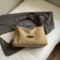 Minimalist earth-tone suede tote bag with adjustable brown leather strap in still life - Khaki