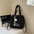 Minimalist black nylon drawstring tote bag with BANATU logo and plush moon pendant - With Pendant / Black