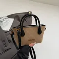 Brown suede mini bucket bag with quilted stitching and black leather strap detail - Khaki