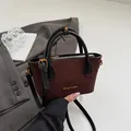 Vintage brown suede bucket bag with quilted stitching and black handles in a stylish setup - Brown