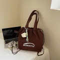 Dark brown nylon drawstring tote bag with white logo and plush pendant accessory - With Pendant / Brown