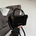 Elegant black quilted crossbody bucket bag with dual handles and golden hardware - Black