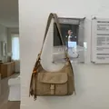 Details der khakifarbenen Hobo-Tasche aus Wildleder mit Schnallentasche und Quaste - Khaki