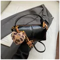 Retro black leather cylinder pillow bag with leopard heart charm and gold hardware - With Pendant / Black PU Leather