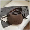 Brown frosted leather crescent shoulder bag with vintage texture and metal grommet strap - With Pendant / Brown