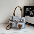 Chic light blue faux leather shoulder bag with brown bow accents and dual pockets - Blue