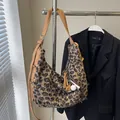 Plush leopard print crossbody bag with adjustable khaki strap and decorative charms - Leopard With Pendant