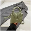 Detail of light green shirt-style mini handbag featuring lychee texture and button accents - Green