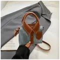 Detail of a shirt-shaped blue denim handbag with brown leather trim and shoulder strap - Denim Blue