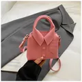 Close-up of pink handbag with shirt collar design and lychee leather texture details - Rose Red