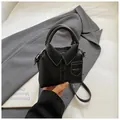 Detail of black mini handbag featuring a creative blazer collar design and white stitching - Black