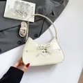 Chic cream bow shoulder bag with glossy PU leather and adjustable long strap - White
