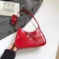 Red glossy leather underarm bag with a chic bow and metallic eyelets on the front - Red