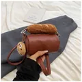 Brown cylindrical shoulder bag with plush baguette handle and cookie charm accessory - Brown