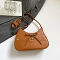 Brown faux leather baguette bag featuring a front bow knot and adjustable long strap - Brown