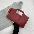Detail of burgundy crocodile embossed leather handbag with vintage gold chain strap - Red