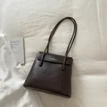 Dark brown lychee texture leather tote bag with unique bead accents on the slim straps - Brown