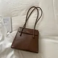 Brown vintage faux leather tote bag with embossed gold logo and long shoulder straps - Brown
