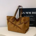 Brown suede tote bag with leather handles and metallic buckle for a retro look - Brown