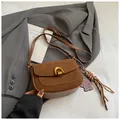 Brown vintage suede saddle bag with horseshoe metal buckle and leopard bear charm - Brown with Pendant
