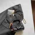 Dark grey pleated dumpling bag with gold chain strap and colorful beaded charm - Black