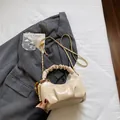 Chic pleated off-white dumpling bag with golden chain and wooden bead charm accessory - Off White