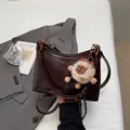 Chocolate brown faux leather crescent tote with adjustable strap and plush charm - With Pendant / Brown