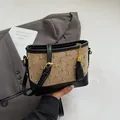 Khaki quilted bucket bag with crystal studs and black faux leather strap detailing - Khaki