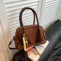 Brown faux suede and leather crossbody handbag with colorful beaded charm accessory - Brown