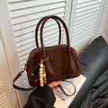 Dark brown suede and leather crossbody bag with wooden bead charm and round handles - Brown