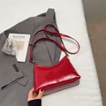 Minimalist red patent leather tote bag with elegant crescent silhouette and gold hardware - No Pendant / Red