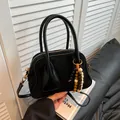 Minimalist black faux suede crossbody bag with decorative wooden beads and slim strap - Black