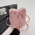 Chic pink plush bucket bag with drawstring closure and elegant gold chain strap - Pink