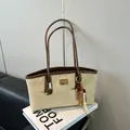 Chic leopard print beige tote bag with long handles and decorative wooden bead charm - Khaki With Pendant
