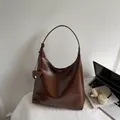 Dark brown high-shine faux leather shoulder bag with decorative mini pouch and knot strap - Brown