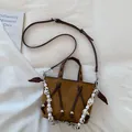 Detail shot of brown faux suede tote bag with spotted scarf and metal eyelets - Brown
