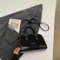 Chic black faux leather handbag with leopard print panel and golden hardware detail - Black