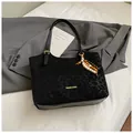 Black vintage oil wax leather tote with leopard embossing and beaded tassel charm - Black With Pendant