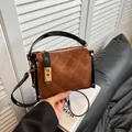 Brown quilted crossbody bag with black handles and golden lock in a stylish vintage design - Red Brown