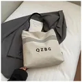 Chic cream canvas bucket bag with black QZBG lettering and stylish wavy stripes - Off White