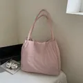 Minimalist soft pink quilted tote bag for women showing spacious interior and sleek straps - Pink