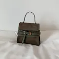 Retro style dark brown suede handbag with green straps and gold buckle detail - Green