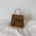 Brown suede handbag with gold buckle and top handle in a minimalist vintage style - Brown